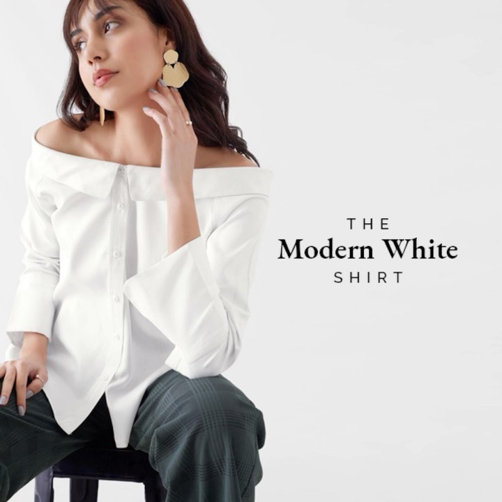 The Label Life - #TheLabelEssential: Tailored to emanate an effortless feel, this off-shoulder high-low shirt is a step beyond the basic white shirt, owing to its sleek folded down collar and side sli...