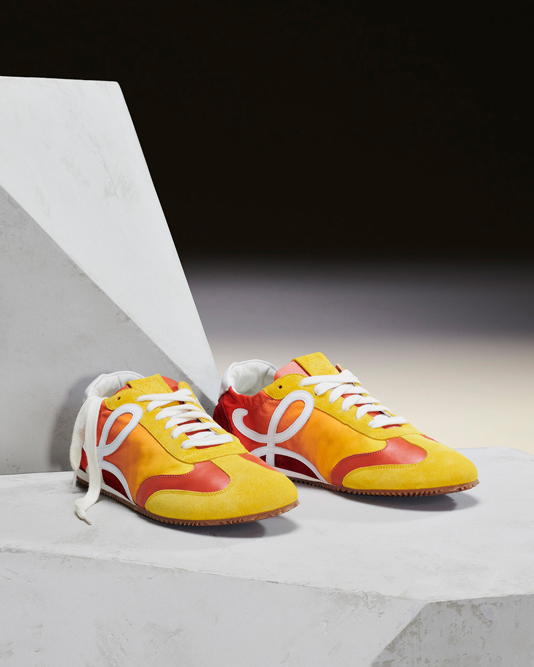 LOEWE - The Ballet Runner arrives in new colourways.

A lightweight sneaker with supple sole and elasticated sides combining the construction of a ballet pump with the style of a 1970s track shoe.

Av...