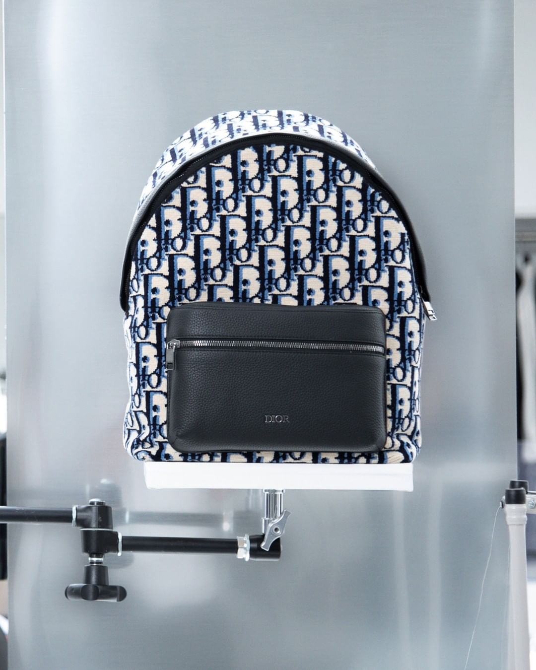 Dior Official - Against the sleek black leather of its zipped front pocket, the new wool-embroidered #DiorOblique Tapestry technique provides a textured and bold graphic contrast on the 'Rider' backpa...