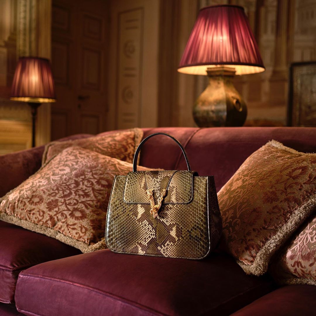 Versace - At home with the #VersaceVirtus bag - photographed in a grand mansion on Lake Como, the Virtus Top Handle makes itself comfortable. Shop the latest accessories through the link in bio. #Vers...