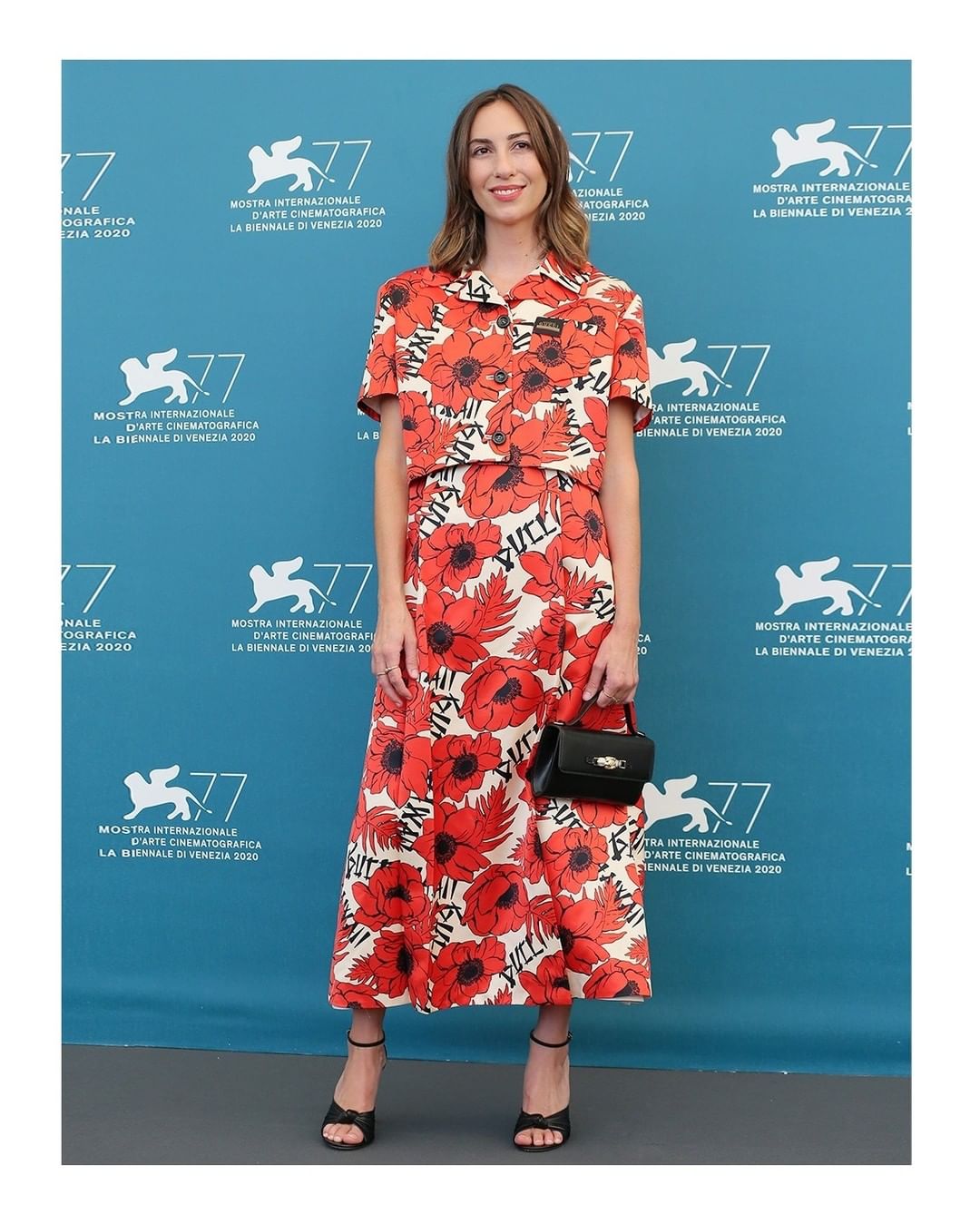 Gucci Official - Gia Coppola @mastergia wore a #GucciPreFall20 printed silk duchesse jacket with embroidered label detail with a boat neck midi dress, high heel sandals with knot and a leather clutch...