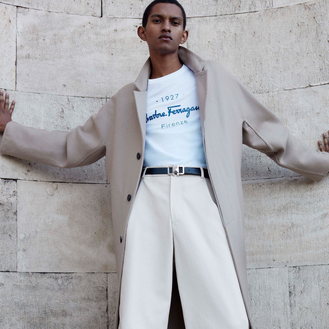 Salvatore Ferragamo - Signature Move: the essential and iconic 1927 Signature T-shirt paired with a casually elegant cashmere kimono sleeve overcoat and wide parchment stretch Nappa trousers. #Ferraga...