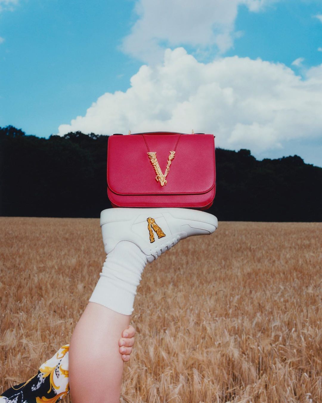 Versace - Feeling flexible - the #VersaceVirtus shoulder bag rests steadily on the sole of our Ilus sneaker in an act of perfect V symmetry. Shop the styles through the link in bio. #VeryVersace